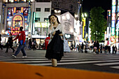 Young woman, cellular phone, mobil phone, night, shopping, East Shinjuku, Tokyo, Japan