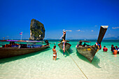 Boats anchored at beach, Tourists with lifejackets standing in water, Ko Poda in background, Laem Phra Nang, Railay, Krabi, Thailand