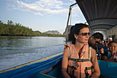 Young woman having a boat trip, Phang-Nga Bay, Ao Phang Nga Nation Park, Phang Nga, Thailand