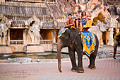 Tourists riding on a elephant, Palace of the Elephants, Phuket Fantasea, Nighttime Cultural Theme Park, Kamala Beach, Phuket, Thailand