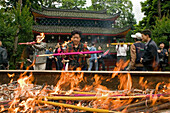 pilgrims burn incense sticks and candles, main hall, fire, red, Wannian monastery and temple, China, Asia, World Heritage Site, UNESCO