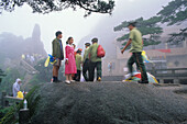 Tourists and police men in the fog in front of Jade Screen Hotel, Huang Shan, Anhui province, China, Asia