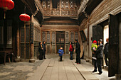 People at the traditional courtyard of a residential house at the village Hongcun, Huang Shan, China, Asia