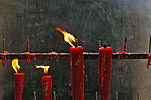 Red candles burning at temple entrance, flame, fire, China, Asien