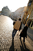 Couple walking over Ovocny Trh Square, Stare Mesto, Old Town, Prague, Czech Republic