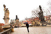 Person walking along Charles Bridge, Mala Strana, Little Quarter, Prague, Czech Republic
