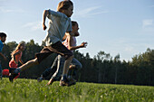 Children running across a field, children's birthday party