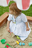Girl playing in sandbox