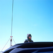 Frau in wetterfester Kleidung und Rettungsweste auf einem Segelboot, Kieler Bucht zwischen Deutschland und Dänemark