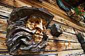 Woodcarving of a man on mountain hut, Krimmler Ache Valley, Hohe Tauern National Park, Austria