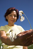Woman picking wild flower