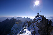 Man at the summit of the Zugspitze in the morning, Bavaria, Germany