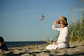 Girl playing at sandy beach, Baltic Sea, Travemuende Bay, Schleswig-Holstein, Germany