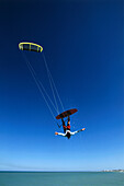Man kiteboarding, big jump freehand