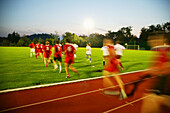 Soccer teams running on field