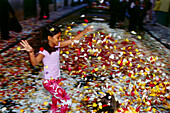 Child playing with blossoms, La Laguna, Tenerife, Canary Islands, Spain