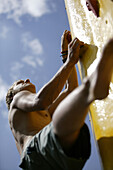 Young man scaling free climbing wall (Popsicle), Haiming, Tyrol, Austria