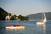 View over Lake Ossiach with a white sailing boat, Ossiach, Carinthia, Austria