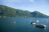 Anchored boats on Lake Maggiore, with mountains in the background, Ascona, Ticino, Switzerland
