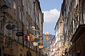 View along famous Getreidegasse with wrought-iron guild and shop signs, Salzburg, Salzburg, Austria, Since 1996 historic centre of the city part of the UNESCO World Heritage Site