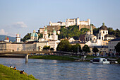 View over the Salzach to the old town and Hohensalzburg Fortress, the largest fully preserved fortress in central Europe, Salzburg Cathedral, Franciscan Church and Collegiate Church, Salzburg, Austria. Since 1996 the historic centre of the city is part of