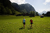 Two women nordic walking over meadow, Kötschachtal, Bad Gastein, Gastein Valley, Salzburg, Austria