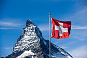 Swiss flag in front of the Matterhorn (4478 metres), Zermatt, Valais, Switzerland