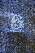Azulejo tile with a picture of St. John on an old wall. The bible tells the story that he baptized Jesus.