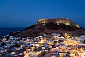 View over illuminated town at night to Acropolis, Lindos, Rhodes, Greece