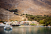 Sailing catamaran anchoring near beach, Pedi, Symi Island, Greece