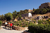 Tourists riding on donkeys to Acropolis, Lindos, Rhodes, Greece