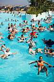 People on floating tyres in the wave pool, Water Park Faliraki, the biggest in Europe, Faliraki, Rhodes, Greece