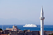 View over old town with a minaret, Agios Nikolaos and a ferry at horizon, Rhodes Town, Rhodes, Greece, (Since 1988 part of the UNESCO World Heritage Site)