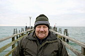 Mature man on pear at Baltic Sea, Mecklenburg-Western Pomerania, Germany