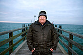 Mature man on pear at Baltic Sea, Mecklenburg-Western Pomerania, Germany
