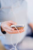 Woman holding a MP3 Player