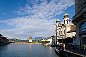 View along river Reuss with Jesuit Curch, first large sacral baroque building in Switzerland, and Kapellbrücke (chapel bridge, oldest covered bridge of Europe) with Wasserturm, Lucerne, Canton Lucerne, Switzerland