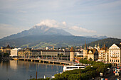 Seebrücke, Kapellbrücke (chapel bridge, oldest covered bridge of Europe) and Wasserturm, mountains in background, Lucerne, Canton Lucerne, Switzerland