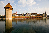 View over river Reuss with Kapellbrücke (chapel bridge, oldest covered bridge of Europe) and Wasserturm to houses at Rathausquai, Lucerne, Canton Lucerne, Switzerland