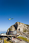 Helicopter flying over Hotel Bellevue in front of mount Esel (2118 m), panoramic view over Lake Lucerne, Pilatus (2132 m), Pilatus Kulm, Canton of Obwalden, Switzerland
