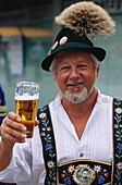 Portrait of a mature Bavarian holding a glass of beer, Munich, Germany