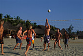 Eine Gruppe von Männer spielen Volleyball, Beach Volleyball, Playa Zicatela, Puerto Escondido, Oaxaca, Mexiko, Amerika