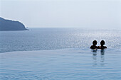 Two people in the swimming pool of a small luxury hotel, La Casa que canta Zihuatanejo, Mexico, America