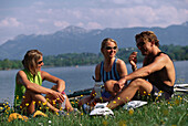 Three people, mountainbiker having a rest, Fünfseenland, Five Lakes, Bavaria, Germany