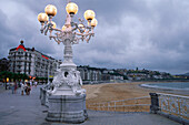 Beach front and promenade with street lamp, Paseo de la Concha, San Sebastian, Basque Country, Spain