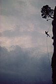 Man free-climbing, climbing up a rock face, climbing rope, sport, Cimaii, France
