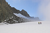 Two mountaineers climbing mount Dent du Geant, Mont Blanc in background, France, Italy