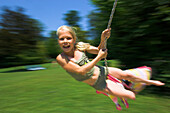 Girl on a swing, Lake Attersee, Salzkammergut, Upper Austria, Austria