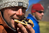 Two men eating in the base camp of Cerro Marmolejo, 6085 m, Ice Climbing, Chile