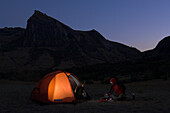 Two people camping at the foot of a mountain, Madagascar, Africa